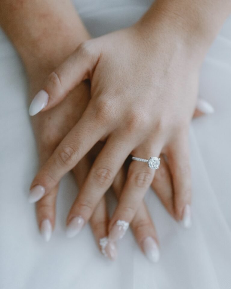 Hands with engagement ring, soft neutral tones
