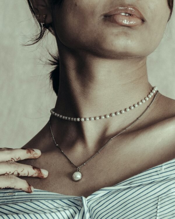 Woman wearing pearl necklace, elegant neutral