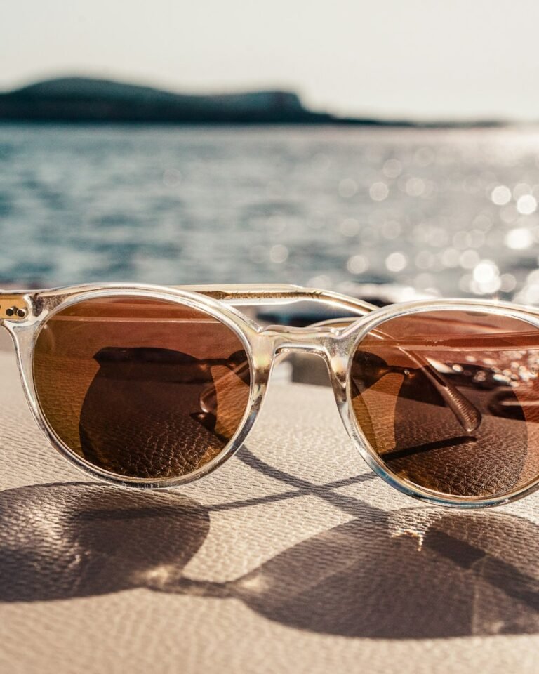 Sunglasses with brown lens, neutral background