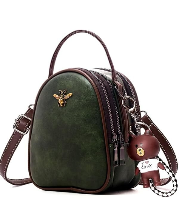 INOVERA green mobile purse handbag featuring multi-zipper pockets, a top handle, brown cross-body strap, and a bear charm keychain.
